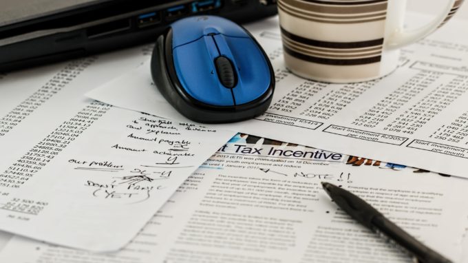 Notes on a desk with a pen, mug and computer mouse