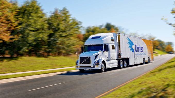 Hilldrup moving truck in motion on a backroad