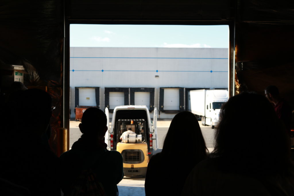 Students watch a shipment be delivered