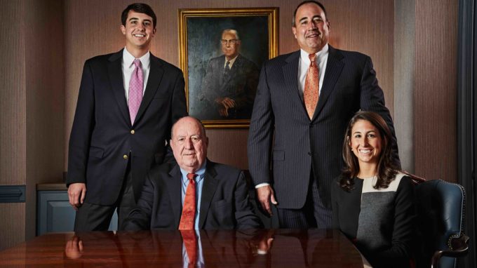 Charlie, Charles G., Charles W., and Jordan McDaniel posing in a conference room