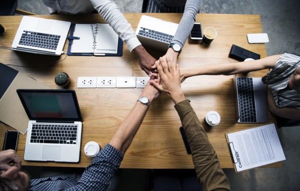 A team puts their hands in to celebrate teamwork