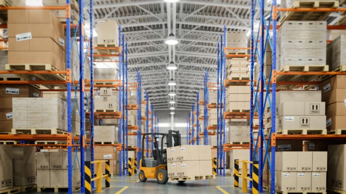 Forklift truck in warehouse or storage and shelves with cardboard