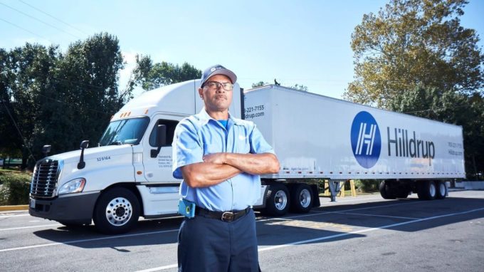 Fred Minor, Hilldrup Van Operator, stands besides a Hilldrup tractor trailer.