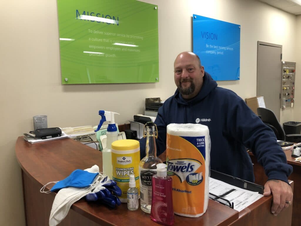 Hilldrup Operations employee with cleaning supplies at the office