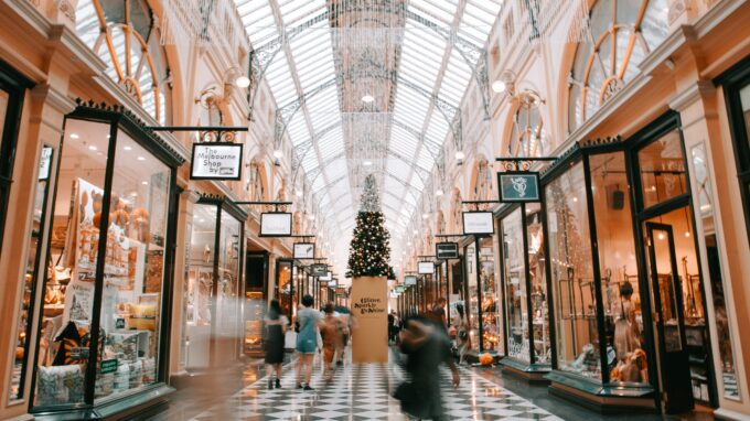 Mall decorated for Christmas with people shopping.