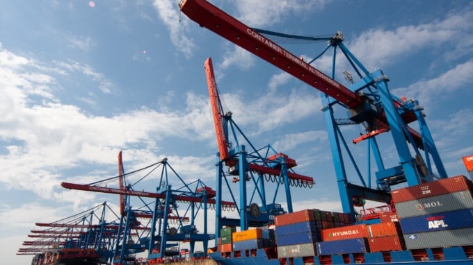 Shipping containers and cranes in a port.