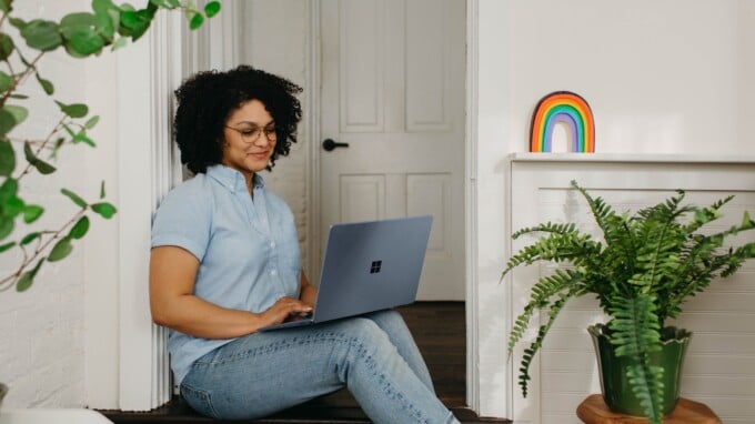 African-American woman working on a laptop at home.