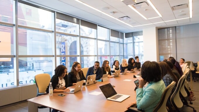 Group of professionals of different ethnicities sitting at a conference table