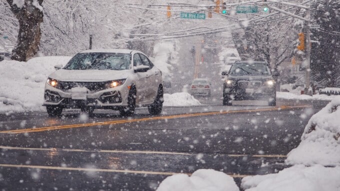 Cars driving on a snowy street