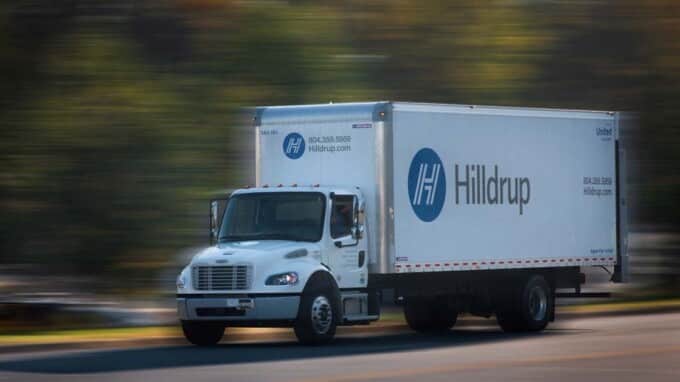 Hilldrup truck driving on road.