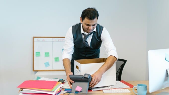 Man packing up office supplies