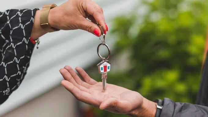 realtor passing the keys of a home to a new homeowner