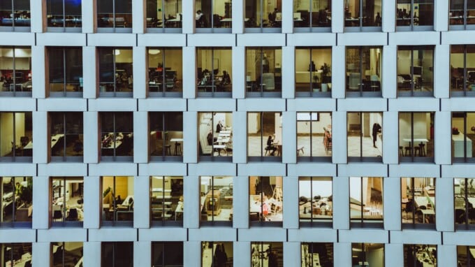 Exterior shot of an office building with many windows.