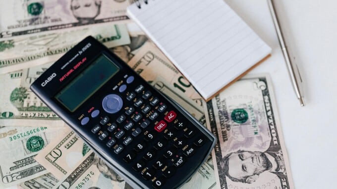 calculator and notepad with cash