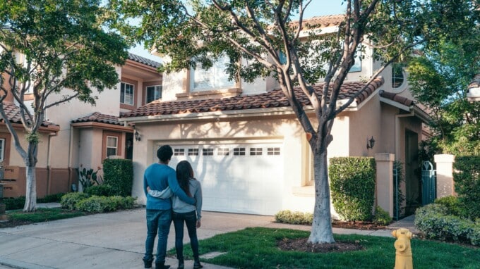 couple outside, looking at new home