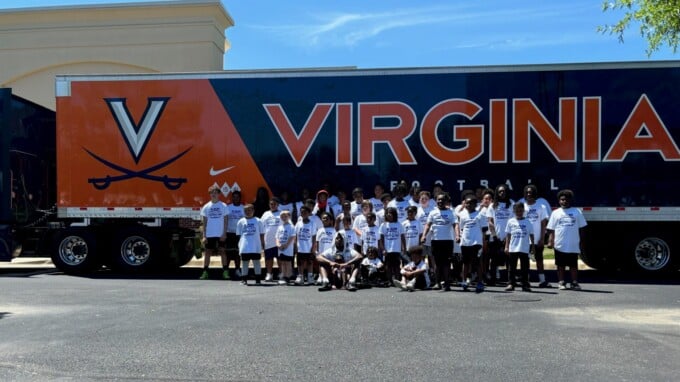 UVA football tractor trailer with Kam Robinson camp campers