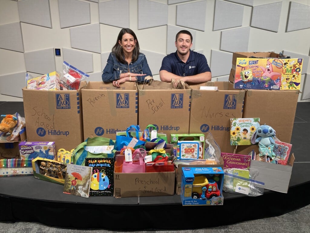 Jordan and William posing with boxes of donated supplies