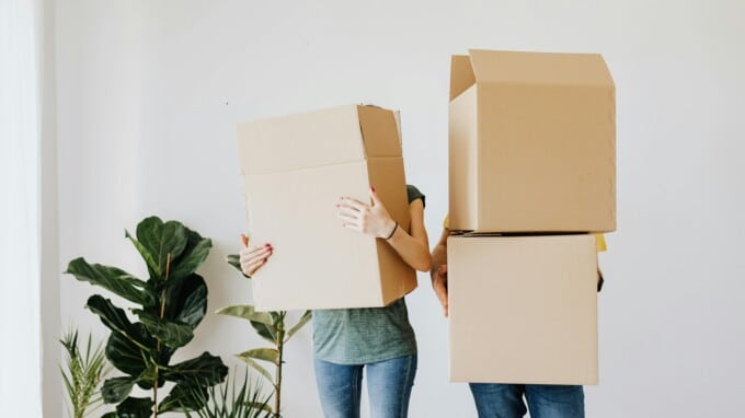 couple holding moving boxes