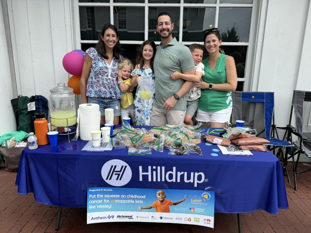 team in front of lemonade stand