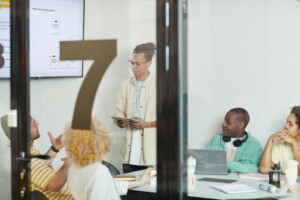 employees together in a conference room with presentation