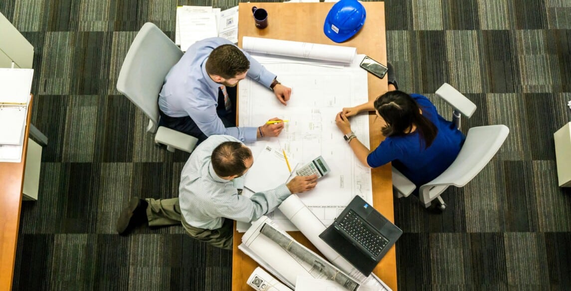 employees at a table working together