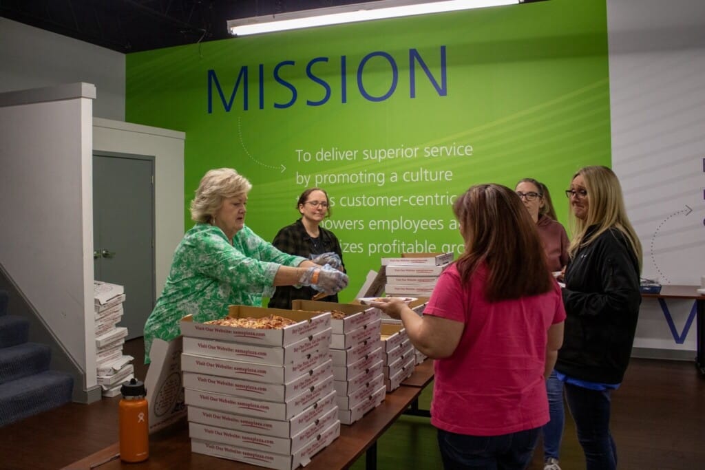 Linda Rivera serves pizza during RUW kick off week 2024 