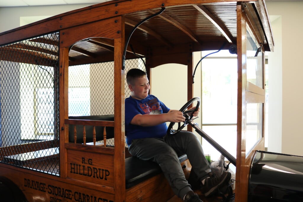 Child sits in 1923 Model T at HQ 