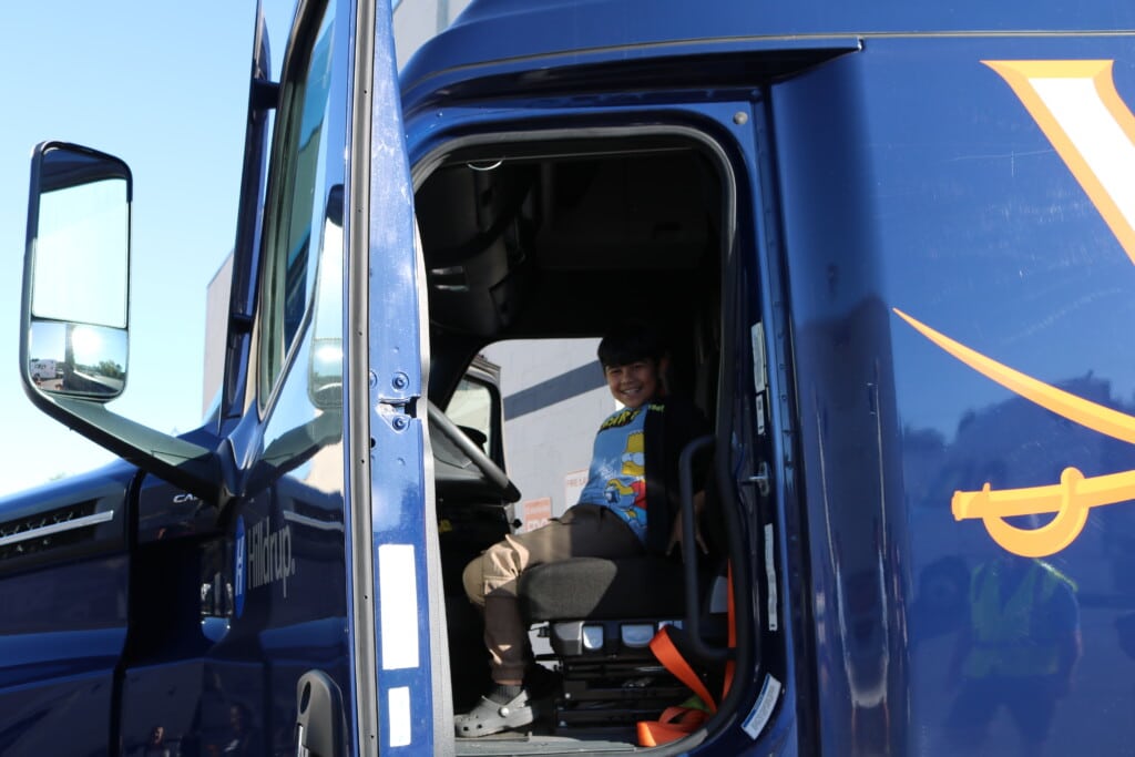 Child sits in cab of Hilldrup truck at Corporate HQ 