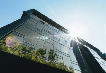 Exterior shot of office building with trees and many windows