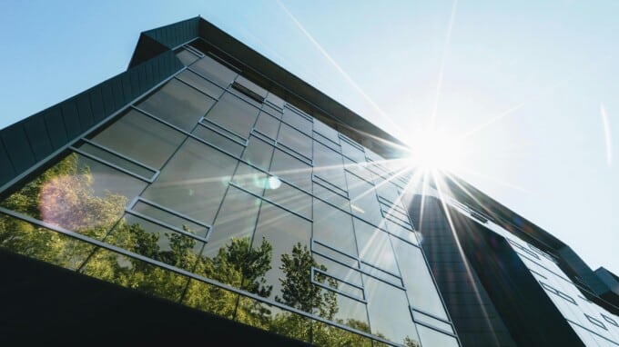 Exterior shot of office building with trees and many windows