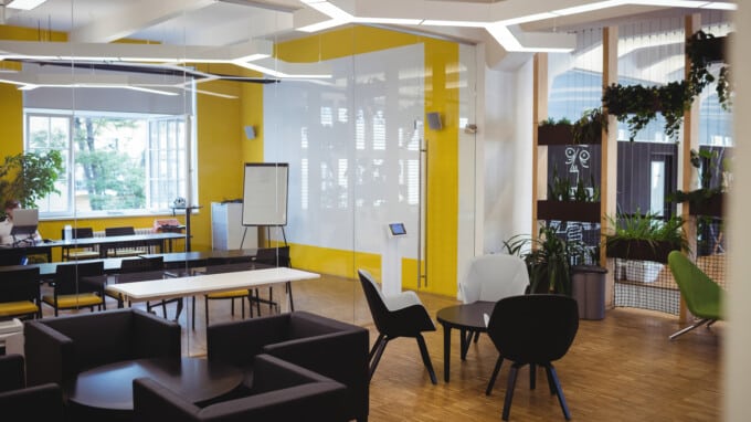 view of empty office with modular furniture and natural light