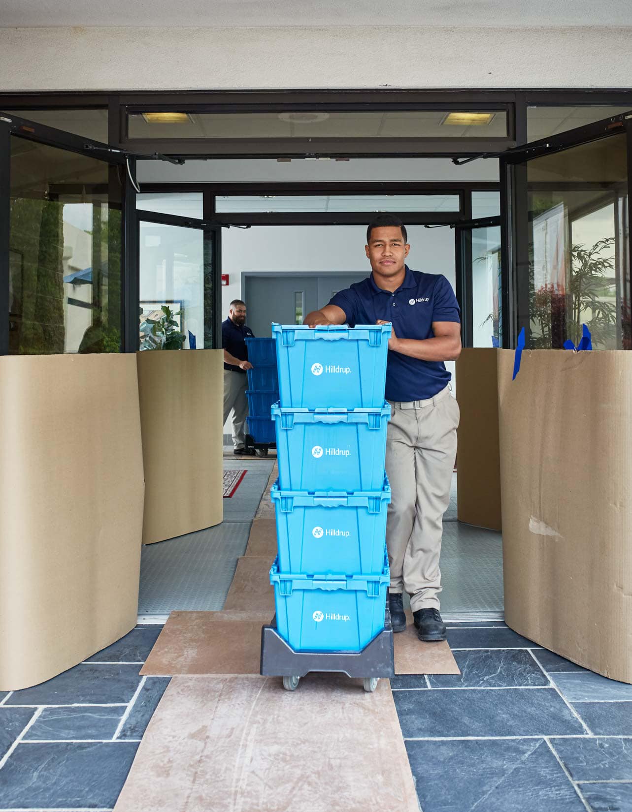 Office movers leaving the facility pushing carts.