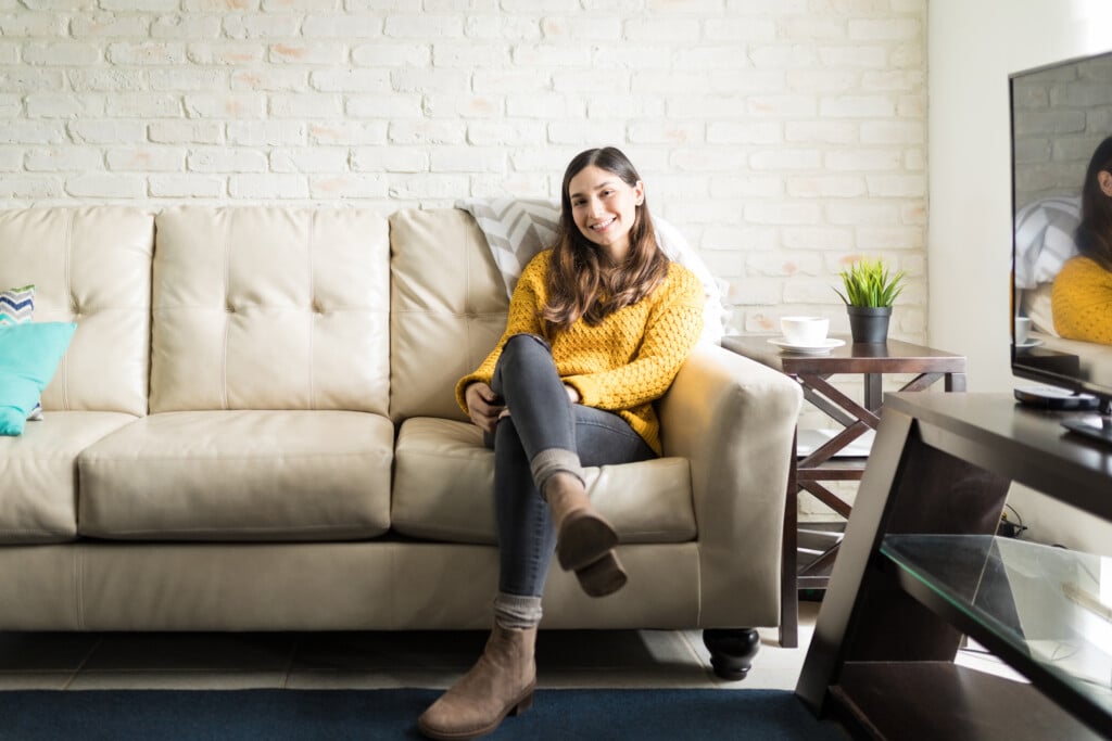 Woman Sitting Comfortably On Sofa