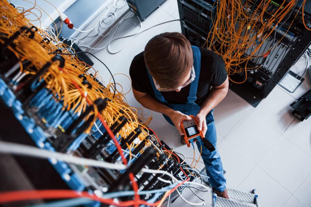 An electrician works on a switchboard